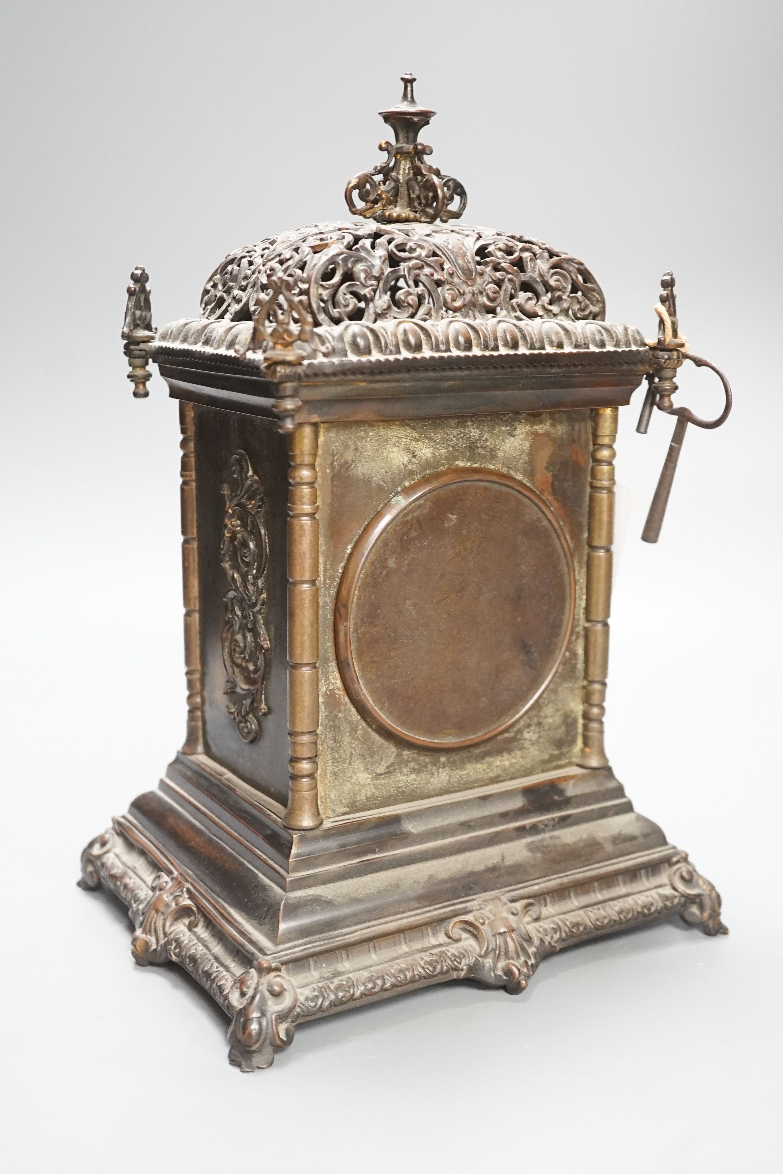 An Edwardian patinated brass mantel clock with key 30cm